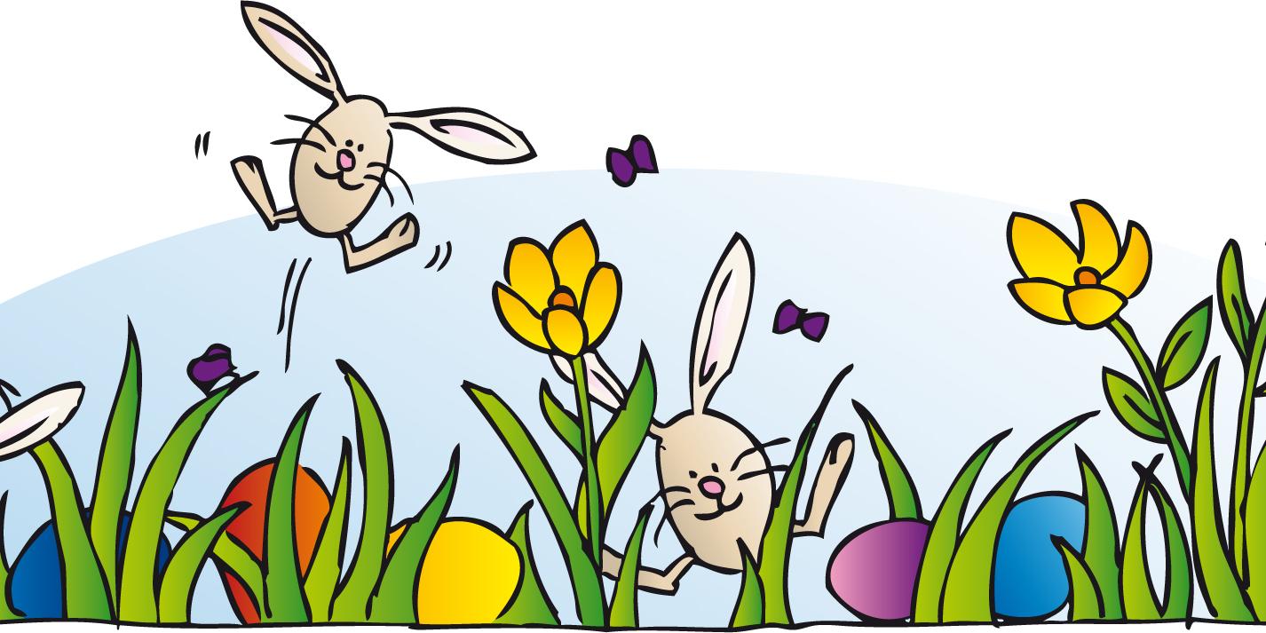 Aus einer grünen, blühenden Wiese springt eine kleiner Osterhase.