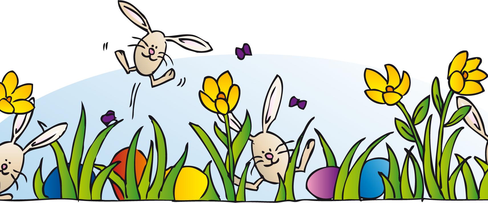 Aus einer grünen, blühenden Wiese springt eine kleiner Osterhase.